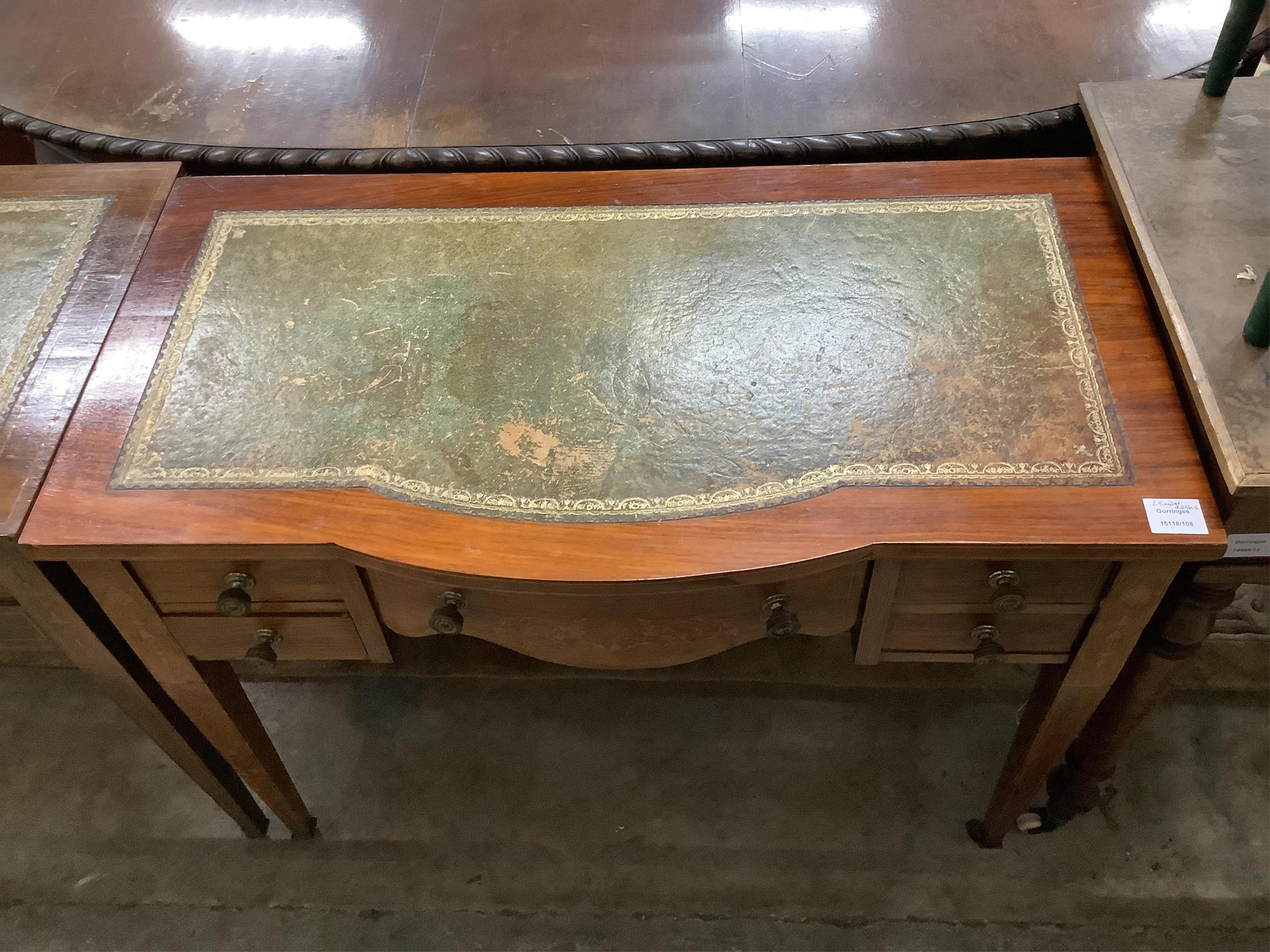 A near pair of Edwardian mahogany kneehole writing tables, larger width 91cm, depth 52cm, height 72cm. Condition - fair